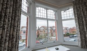 White timber bay vertical sliding windows interior view