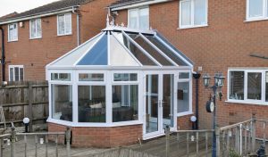 White uPVC Victorian conservatory with a glass roof