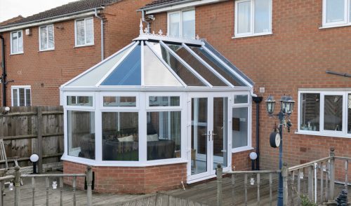 White uPVC Victorian conservatory with a glass roof