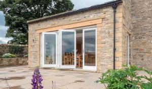 A white open timber bifold door