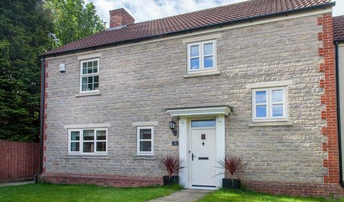 Large white casement window installation