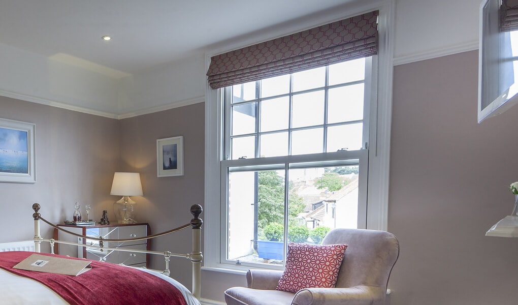 Bedroom with a white uPVC vertical sliding window