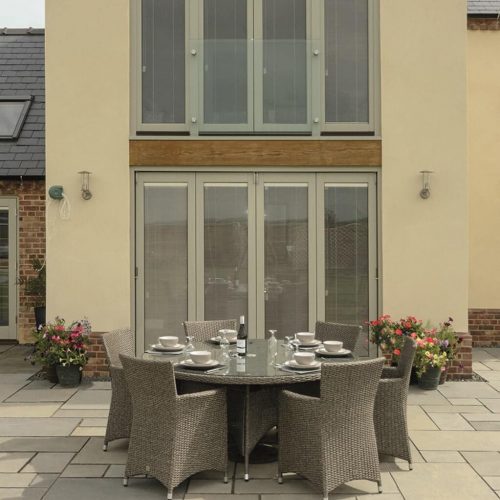 Tall green timber bifold door installation