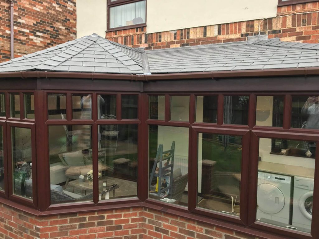 P-shaped conservatory with tiled roof