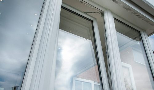 Close up of an open white uPVC tilt and turn window