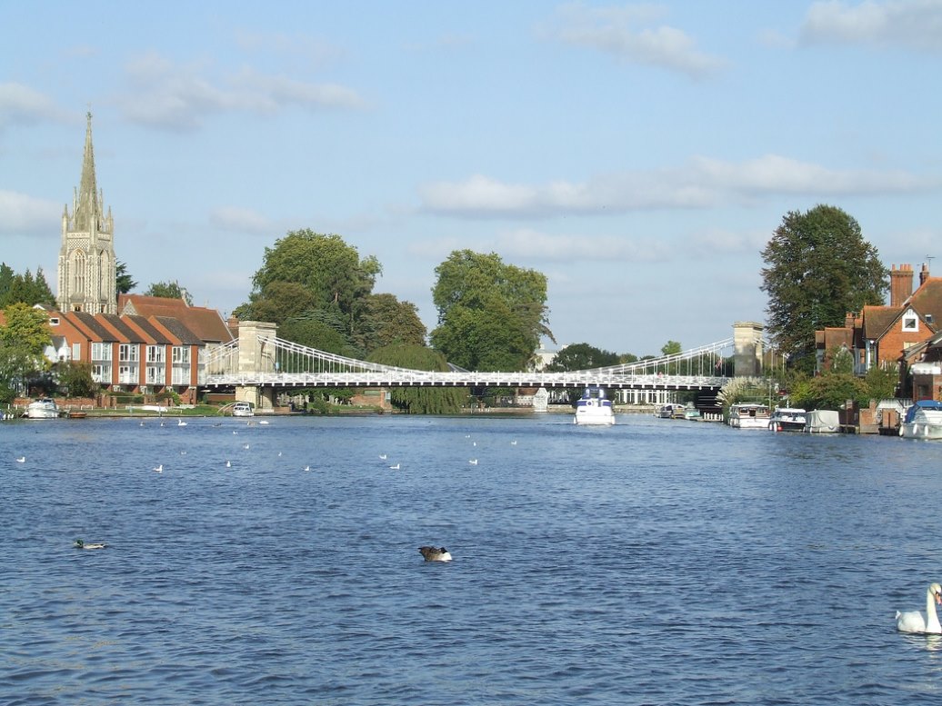 marlow bridge across river thames with a number of ducks and swans